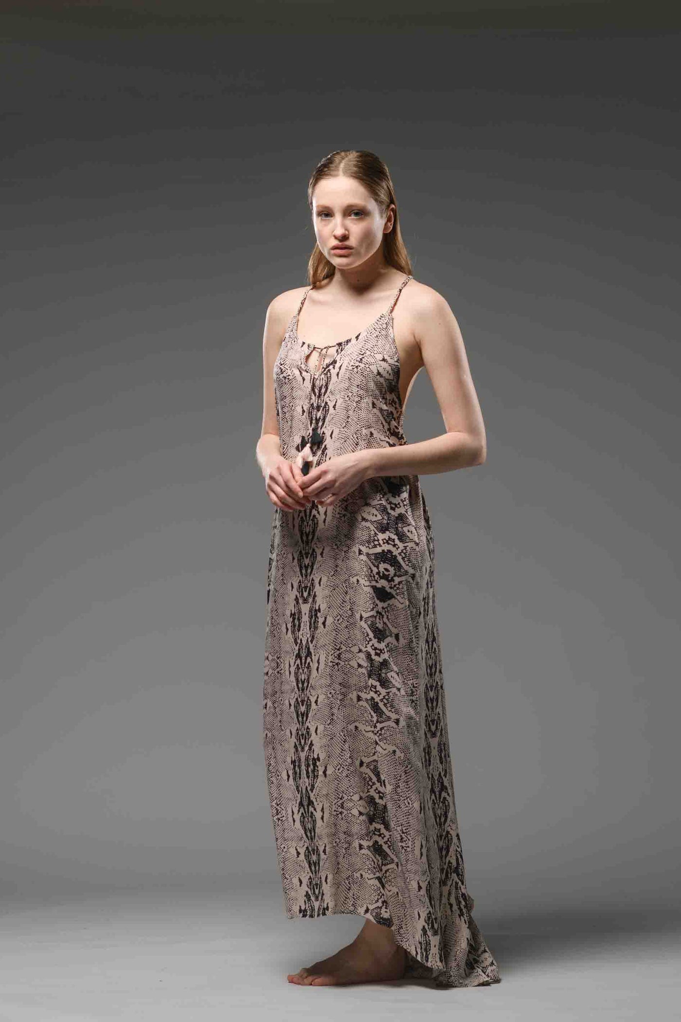  Elegant resort wear python print soft rayon dress. Hand knitted braided cord ropes made of the same fabric, create a special detail net in the back.